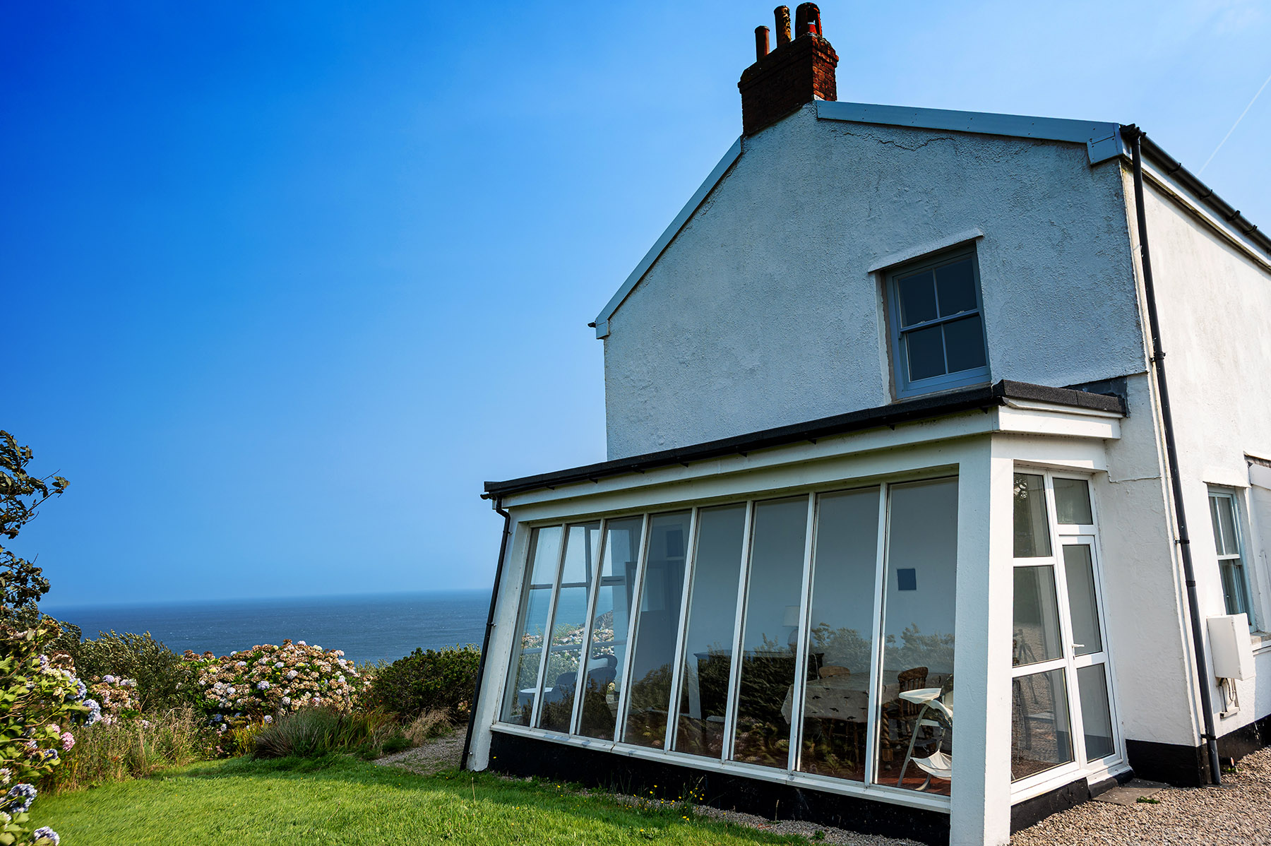 Sunlit conservatory with sea views at Chy Barnett holiday cottage, Gurnards Head