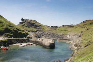 Boscastle harbour and its stone walls seen from the hillside