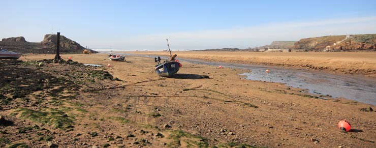 Boats on the beach in front of Budes Lock