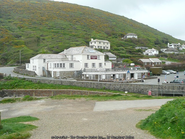 The white Coombe Barton Inn at Crackington Haven with holiday homes on the hillside behind