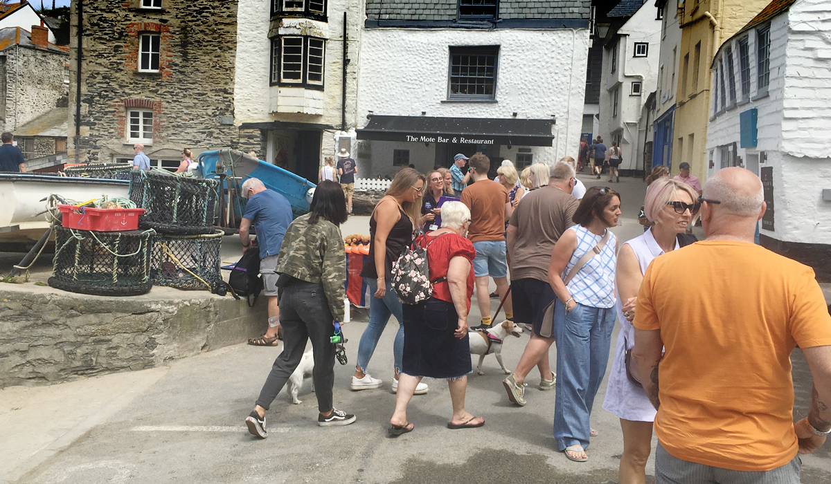 Visitors and fishermen&rsquo;s gear on The Platt at Port Isaac harbour