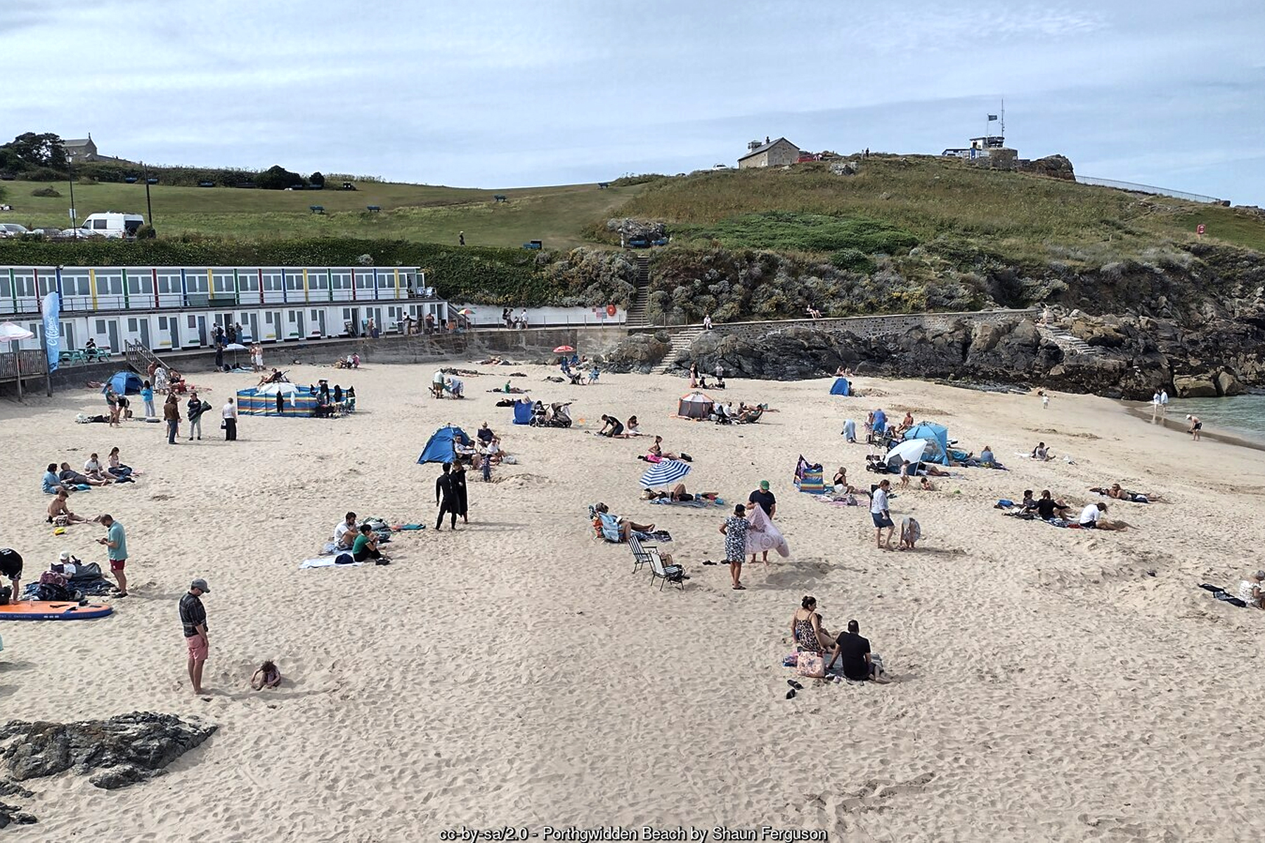 Holiday makers sunbathing on Porthgwidden Beach St Ives Cornwall sheltered cove beneath St Ives Head - Cornwall family beach holidays