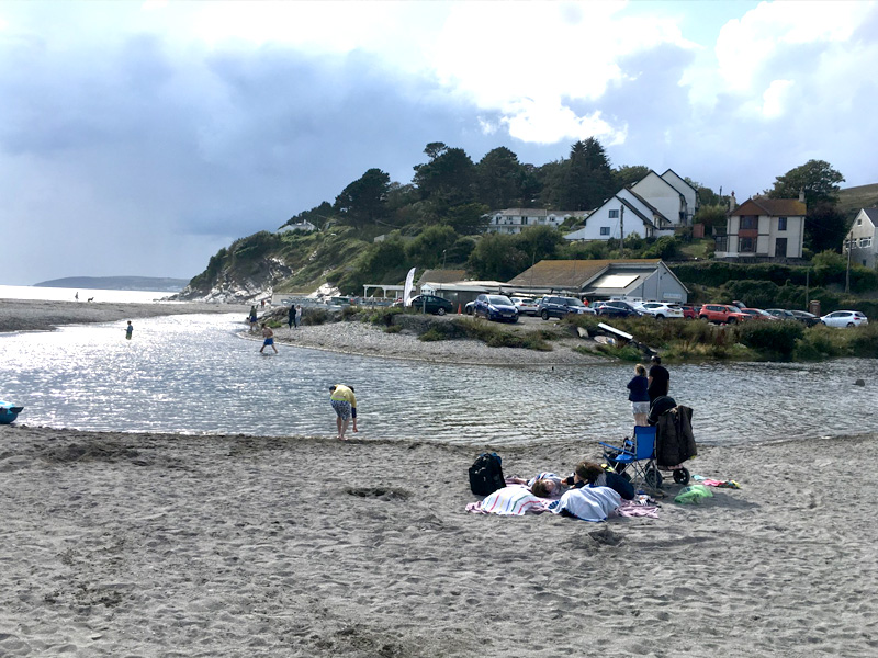 The River Seaton meeting the beach, with rock pools exposed at low tide, Seaton, Cornwall