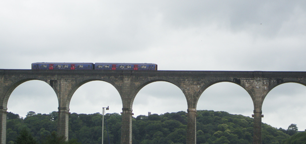 A train crossing Calstock Viaduct high above the River Tamar