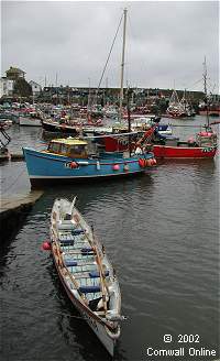 Fishing boats and a pilot gig in Mevagissey inner harbour