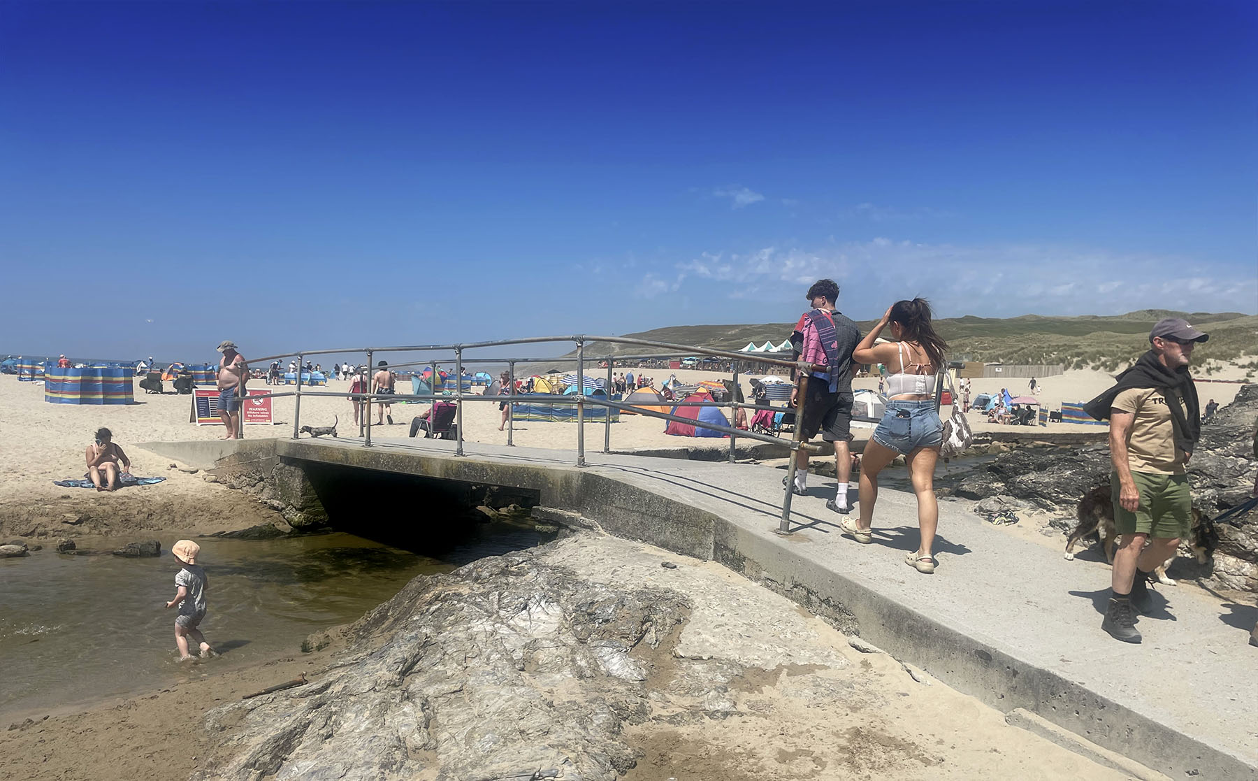 Perranporth Beach footbridge over the Bolingey Stream leading to the Watering Hole and main beach - Cornwall beach holidays