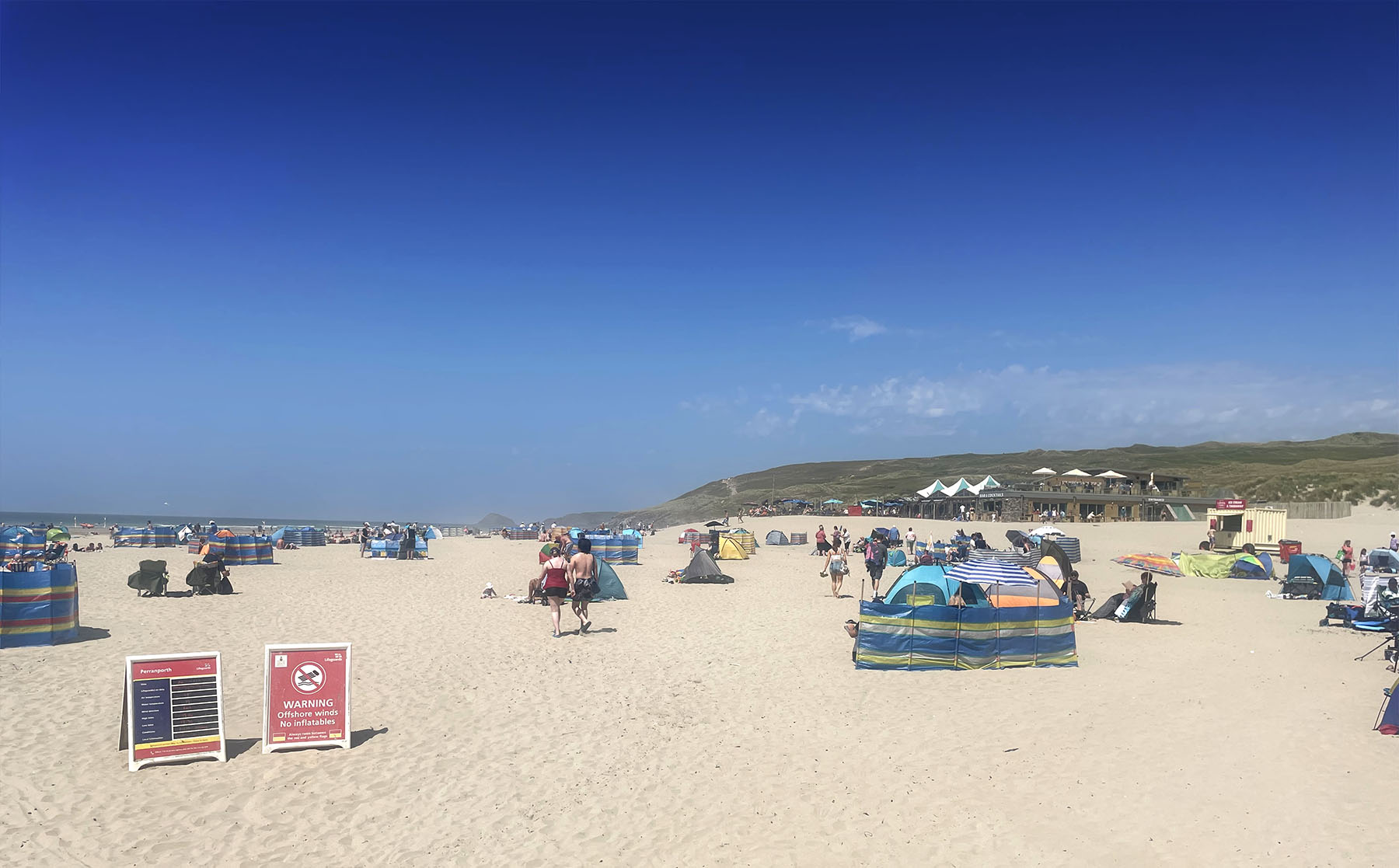 Perranporth Beach busy in the summer holidays looking towards the Watering Hole beach bar - Cornwall family beach holidays