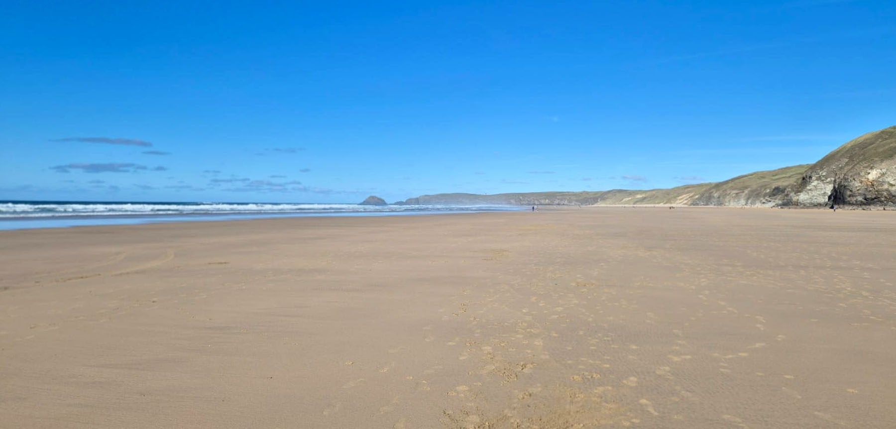 The vast, empty sands of Perranporth beach on an October day